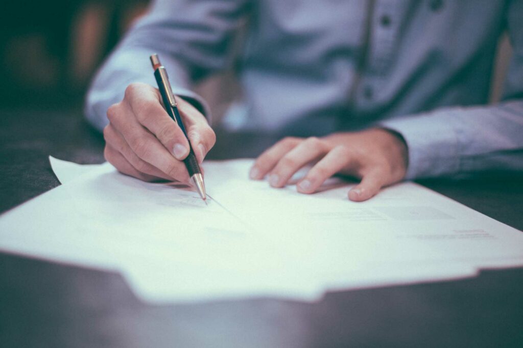 a man filling out a form for business insurance coverage