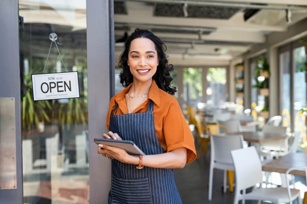 Small business entrepreneur at entrance ofcafe