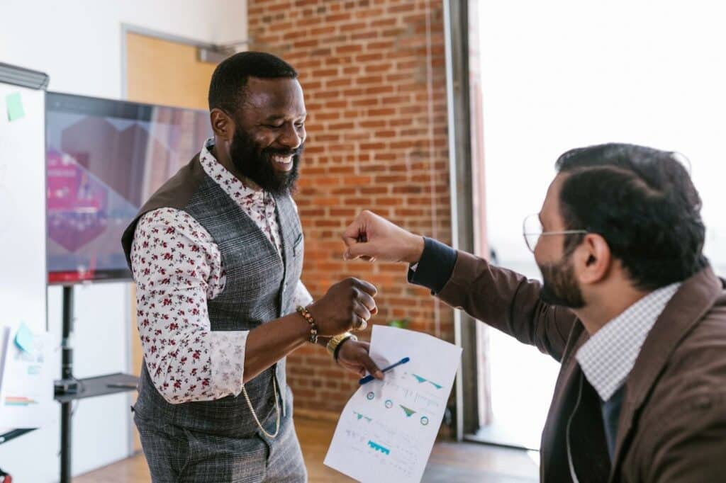 Two co workers celebrating in a business setting