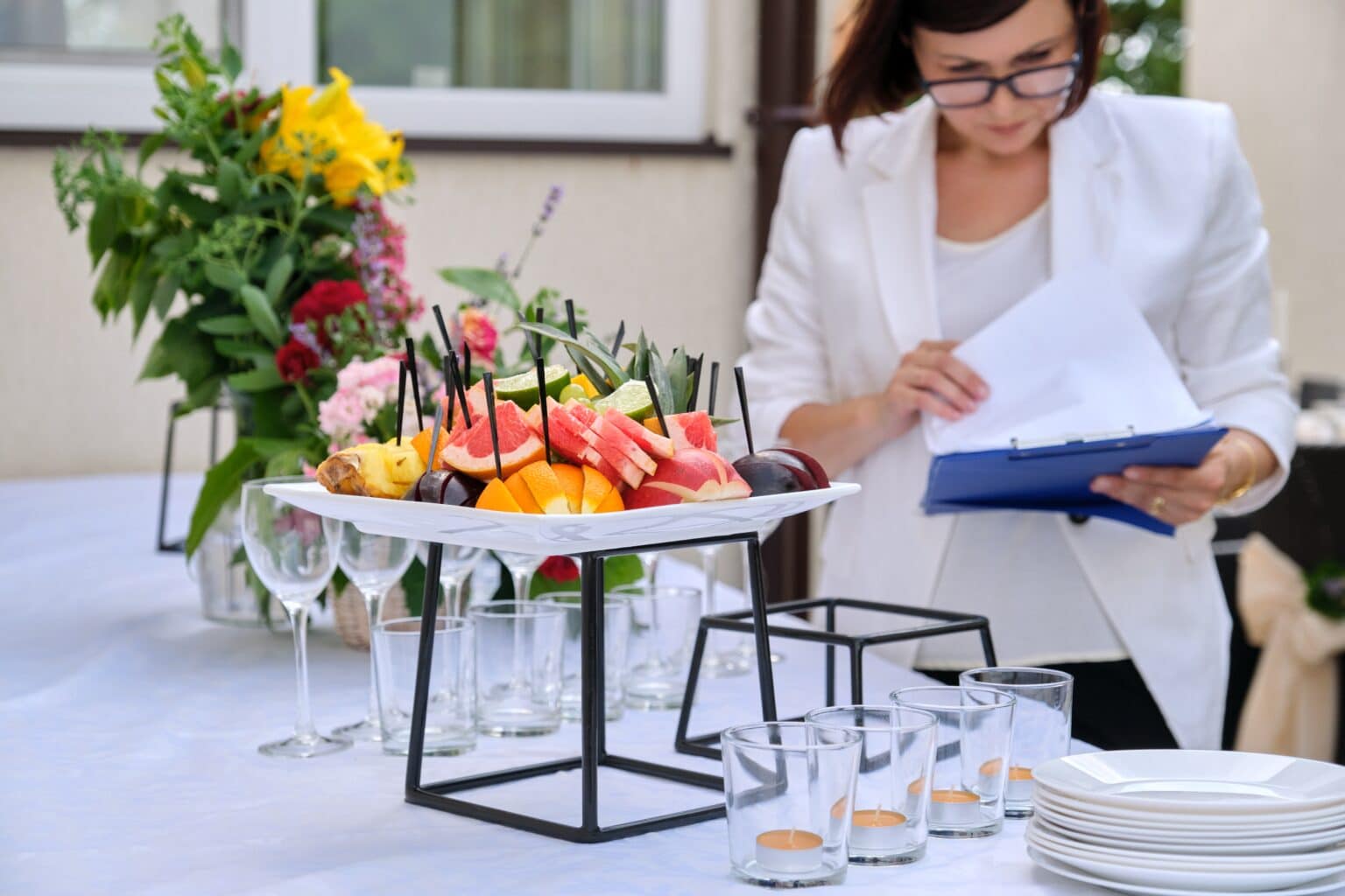 An event player reviewing her event insurance policy next to a decorated banquet table