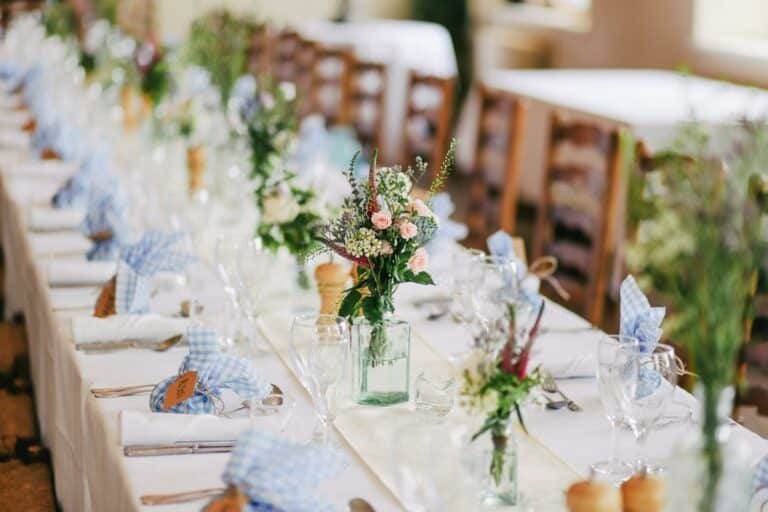 A decorated table with napkins and centerpieces for an event that is covered by event insurance