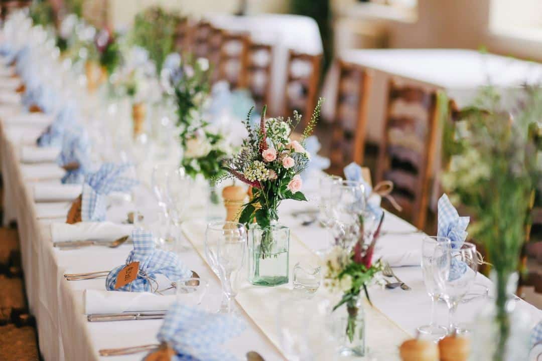 A decorated table with napkins and centerpieces for an event that is covered by event insurance