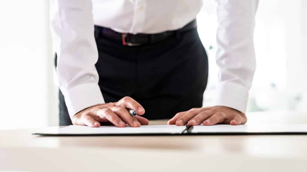 Business employer signing a management liability insurance policy