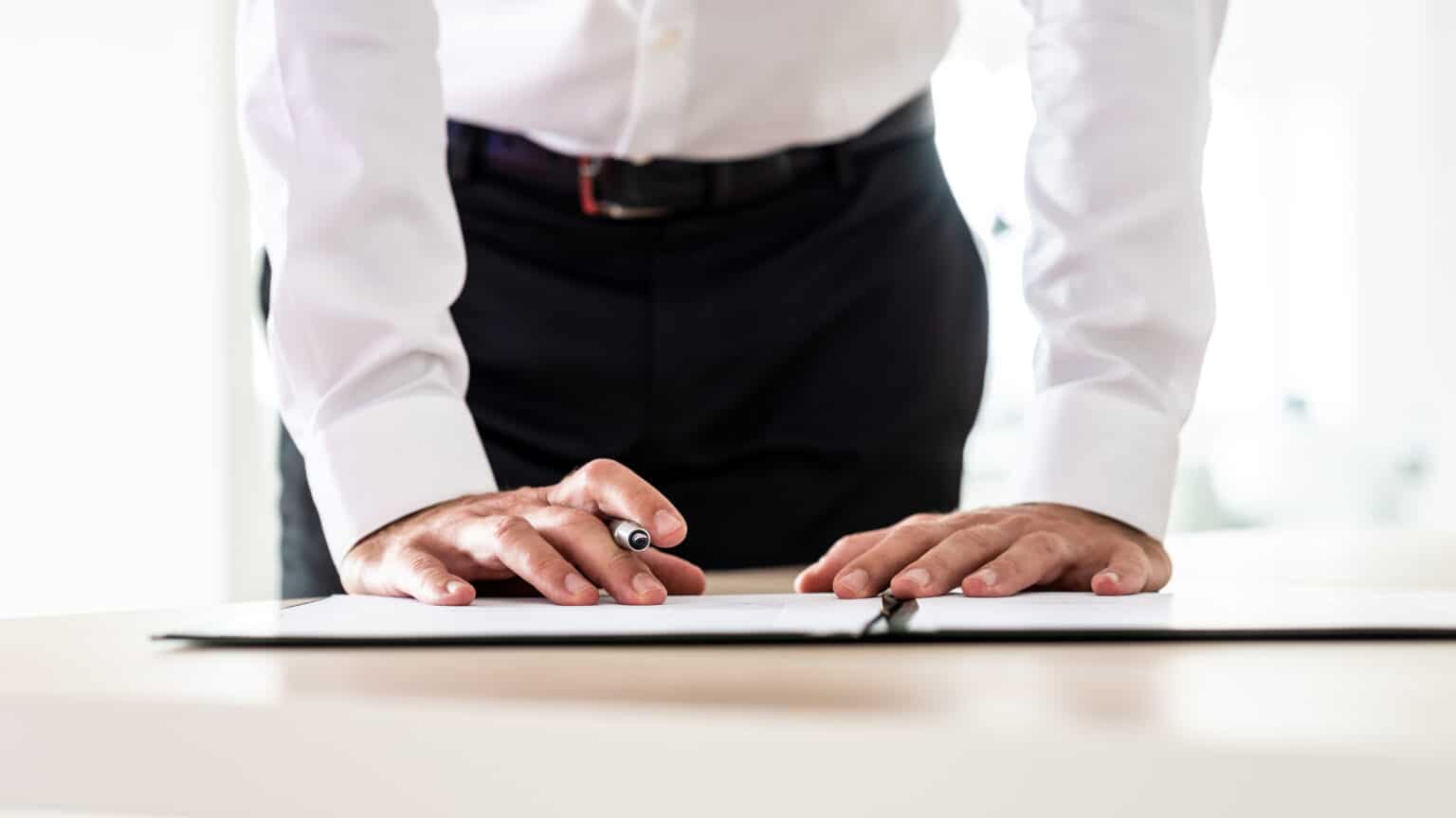 Business employer signing a management liability insurance policy