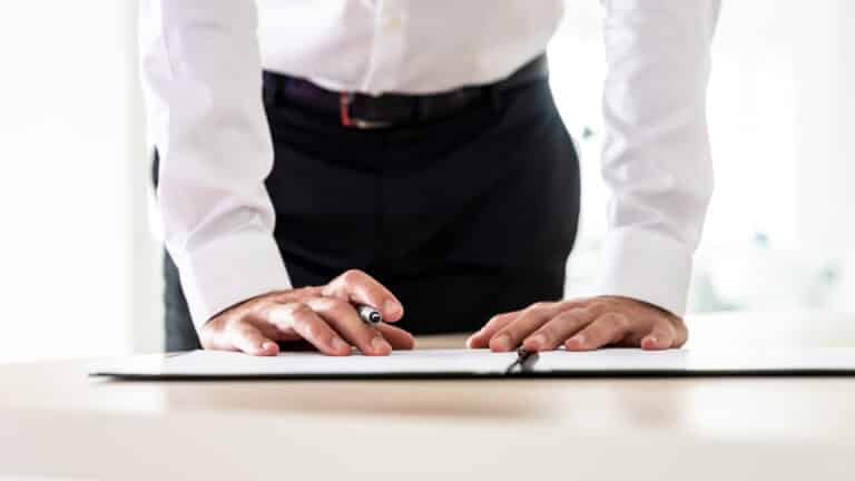 Business employer signing a management liability insurance policy