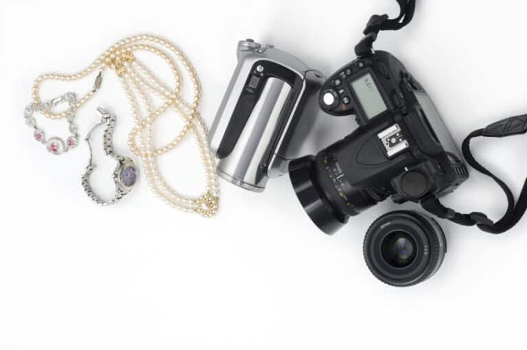 valuable items and jewelry insurance concept with camera and jewelry on a table
