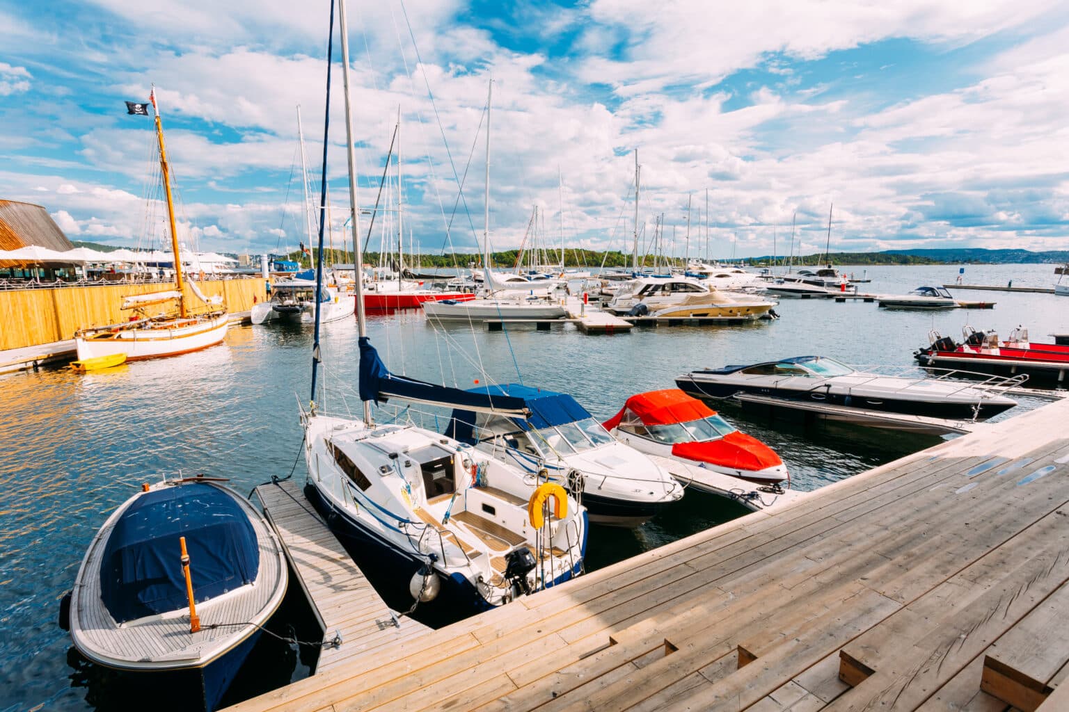 Watercraft insurance concept A Wooden Sea Pier With Moored Boats And Yachts