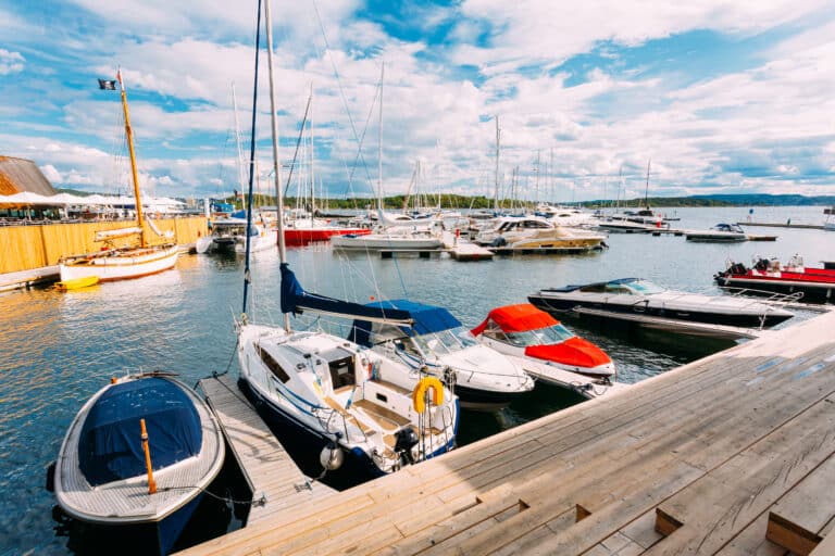 Watercraft insurance concept A Wooden Sea Pier With Moored Boats And Yachts