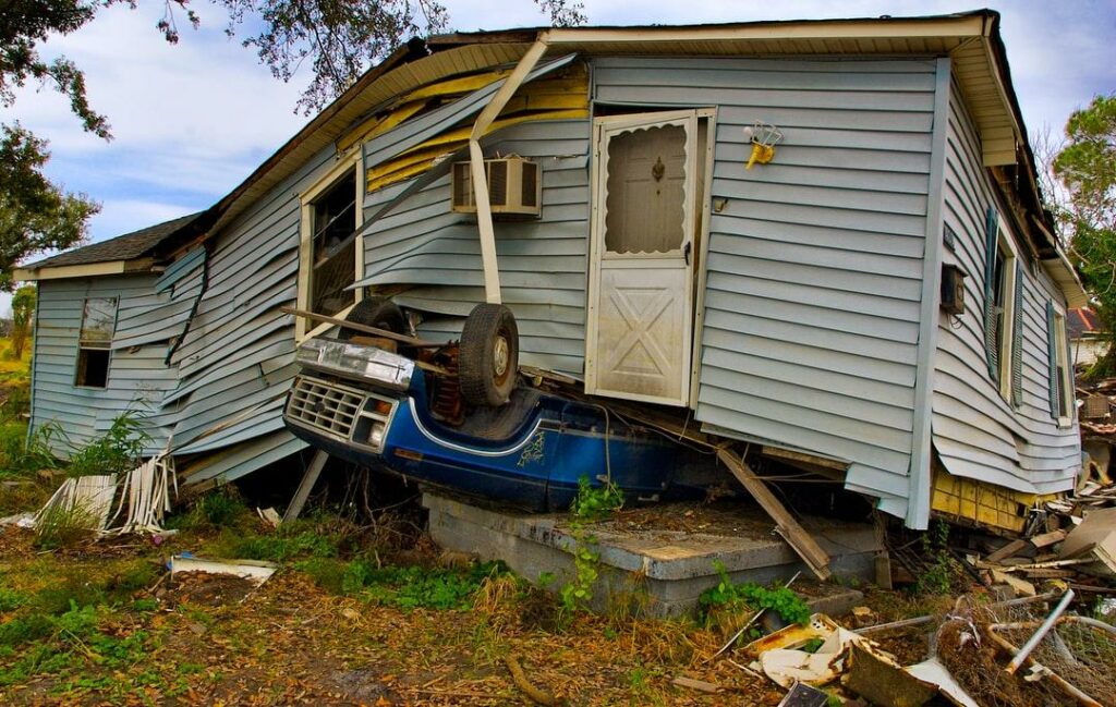 A house on top of a vehicle after a tornado