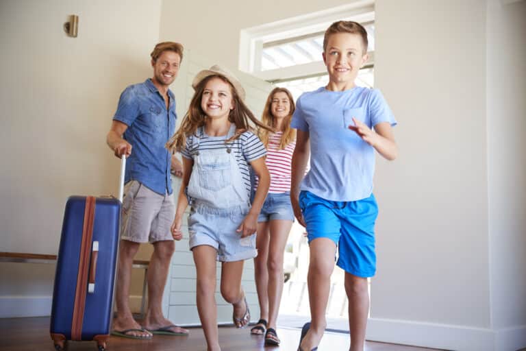 Family arriving at summer vacation rental property