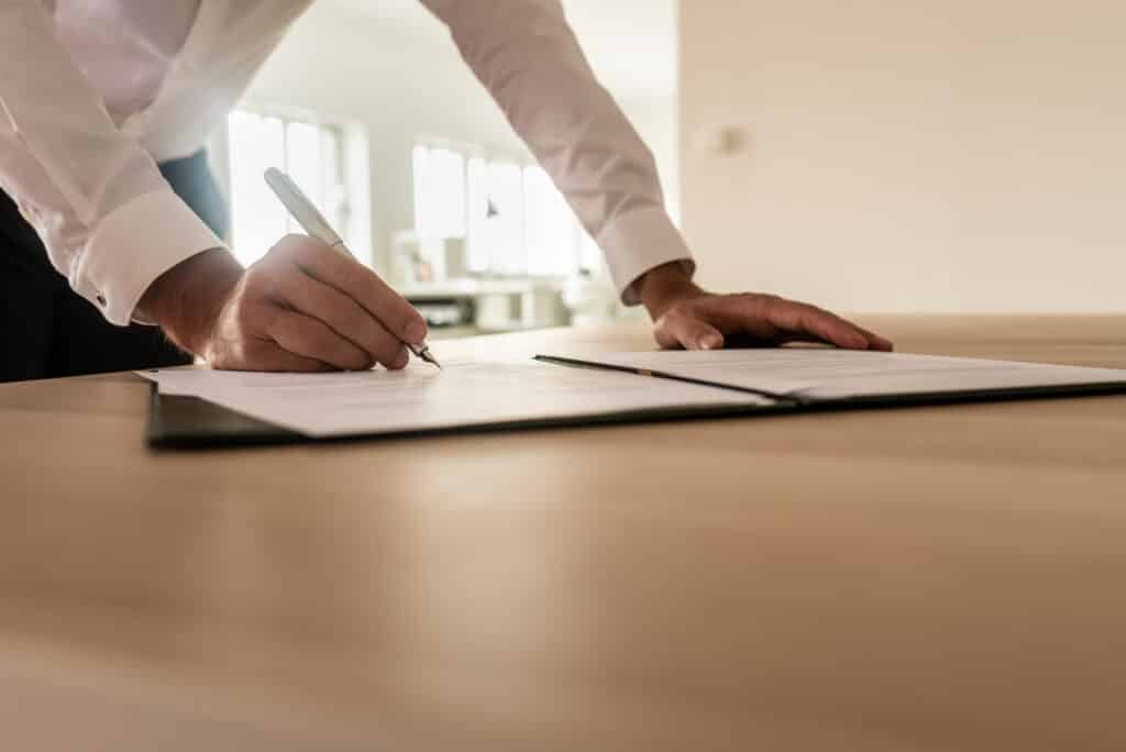 Businessman signing insurance or legal document