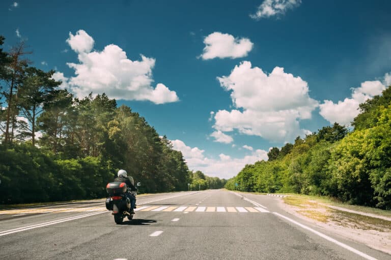Rider On Motorcycle In Motion On Country Road representing Motorcycle Gap insurrance
