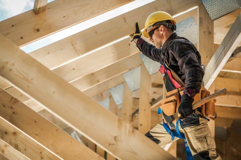 general liability for independent contractors concept with contractor working on house frame