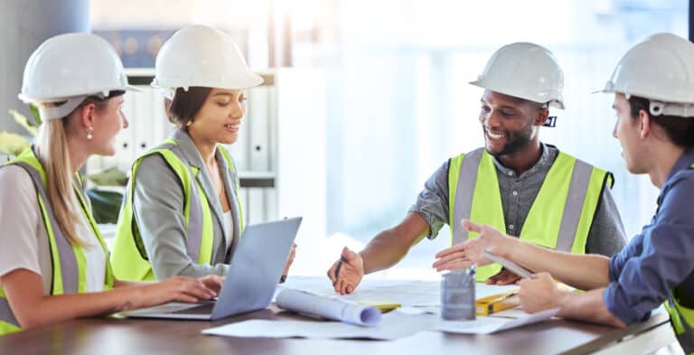 errors and omissions insurance concept with contractors looking at building plans