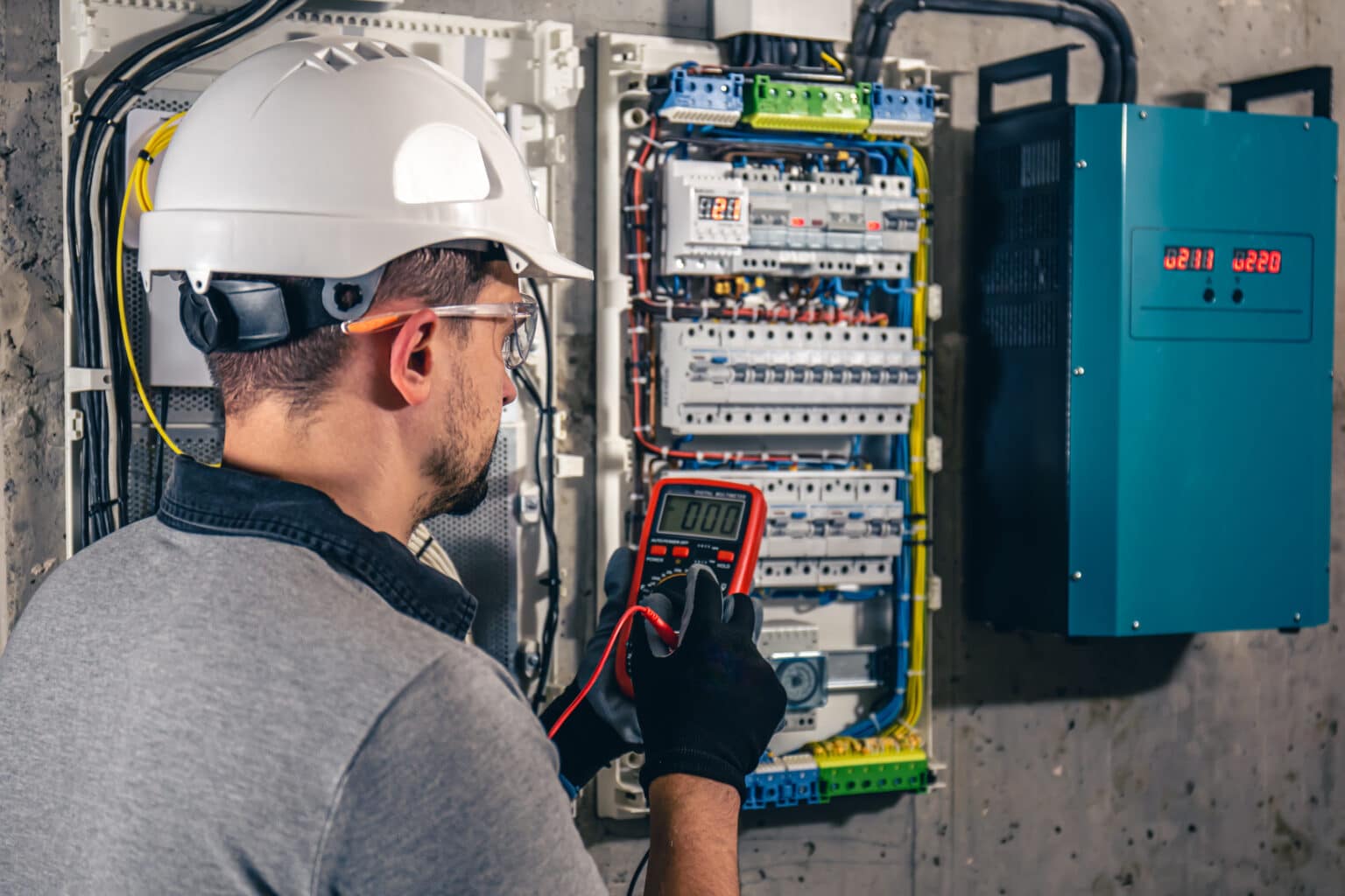 An electrical technician working in a switchboard. electrical contractor insurance concept.