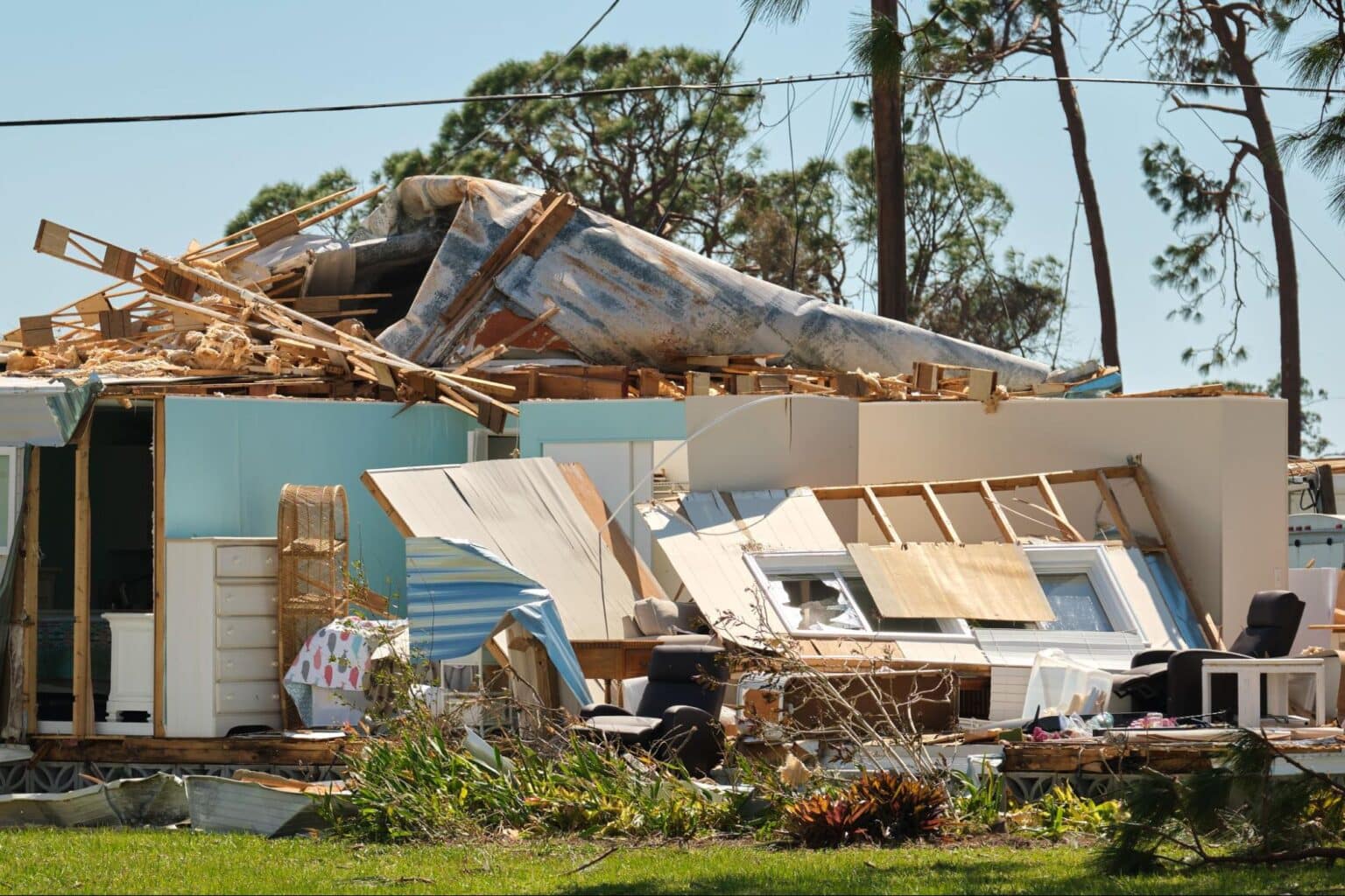Hurricane damage to a house showing extensive structural destruction and debris.