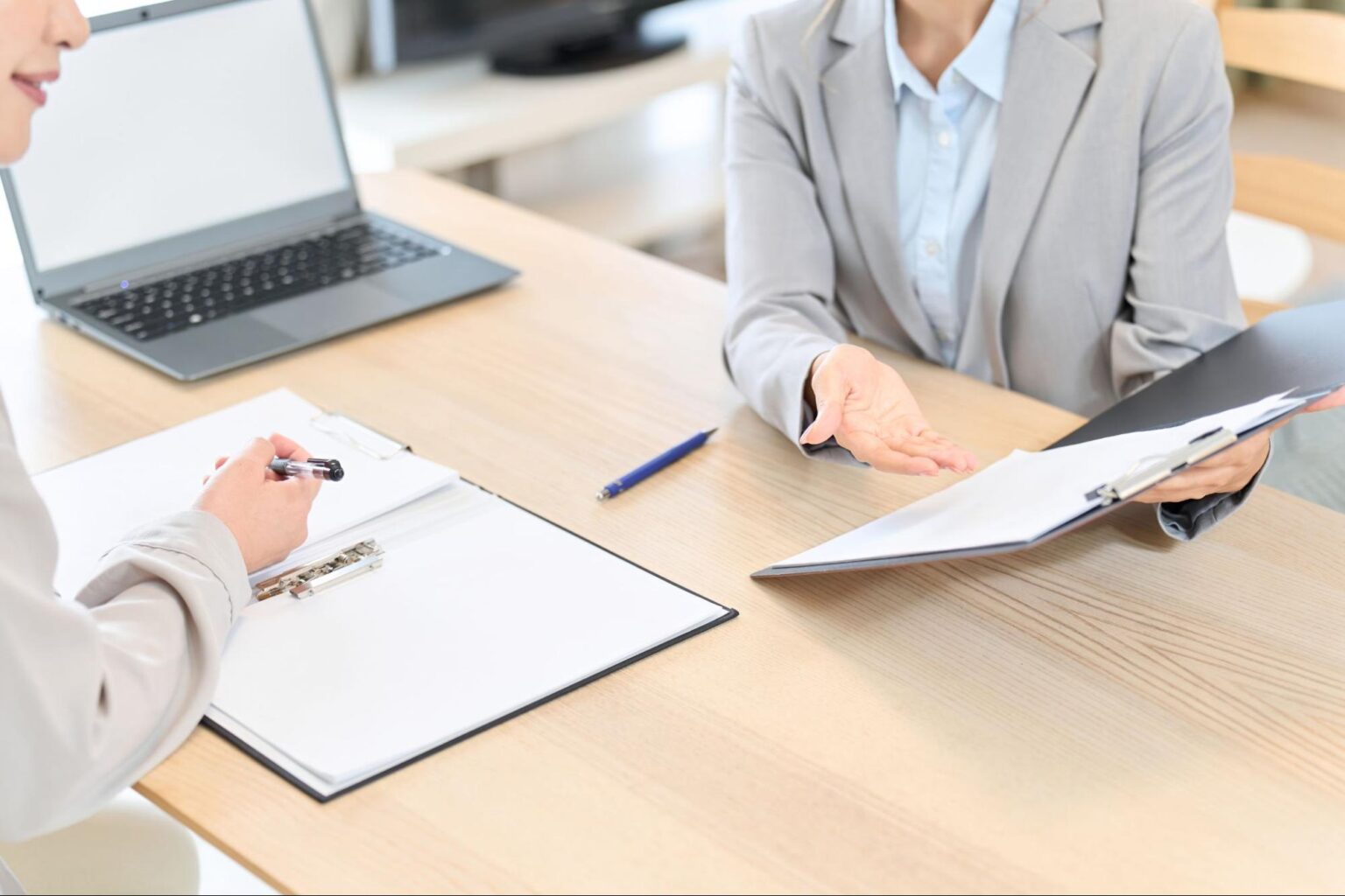 Business meeting with discussions and paperwork on a table.