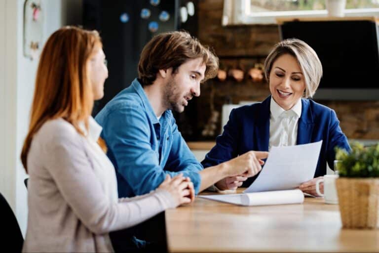 Professionals discussing documents at a modern office table, fostering teamwork and collaboration.