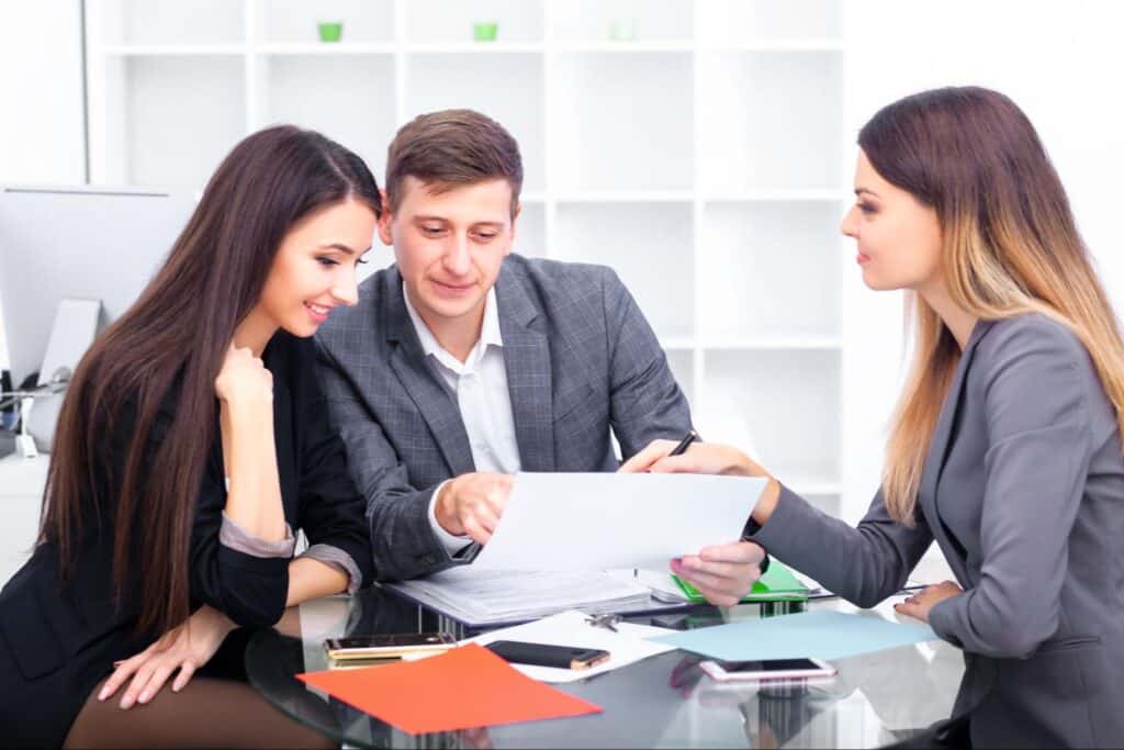 Business team collaborating on a project with documents at a modern office table.