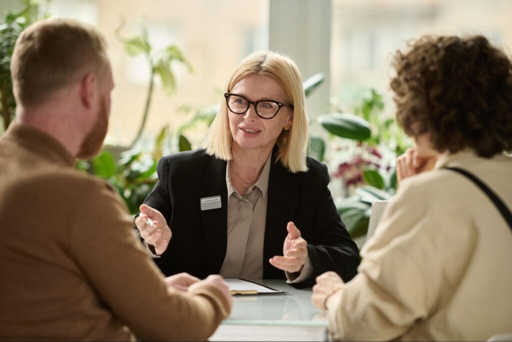 Professional consultant guiding clients in an engaging office discussion.