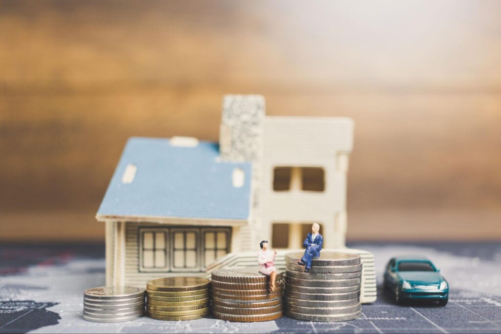 Real estate investment: building wealth with coins and a model house.