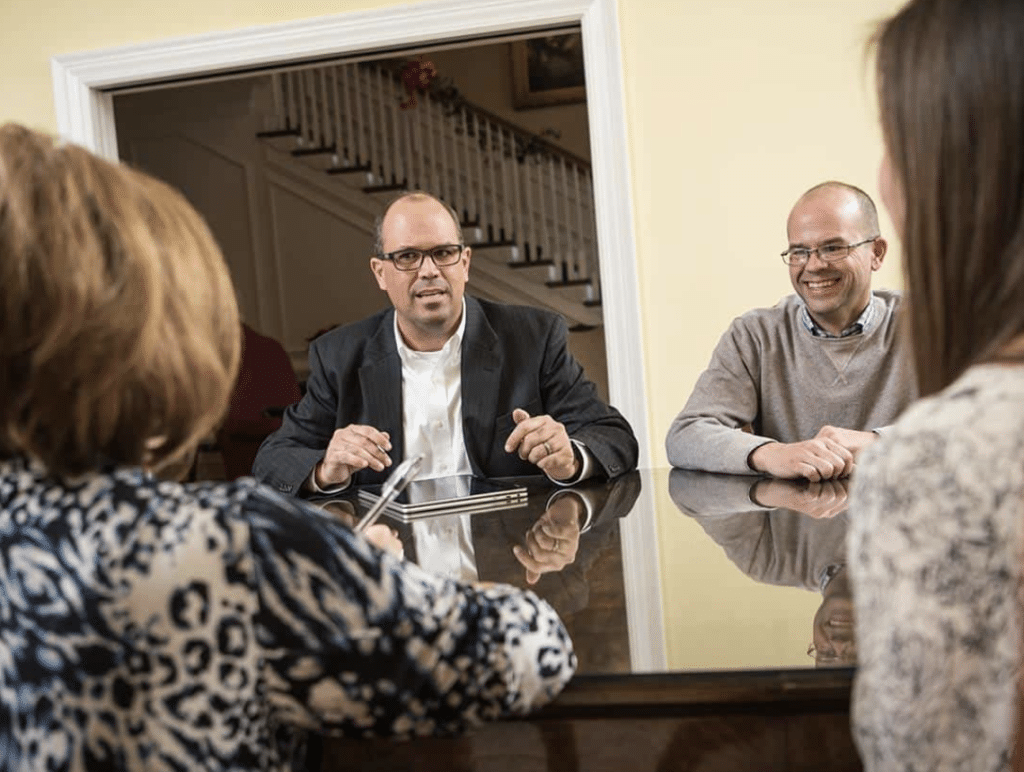 Professionals engaged in dynamic strategic discussions around a conference table.