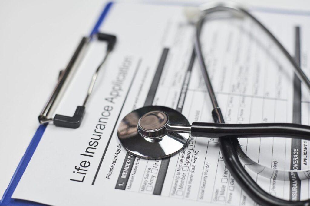 Life insurance application form with a stethoscope for health assessment.