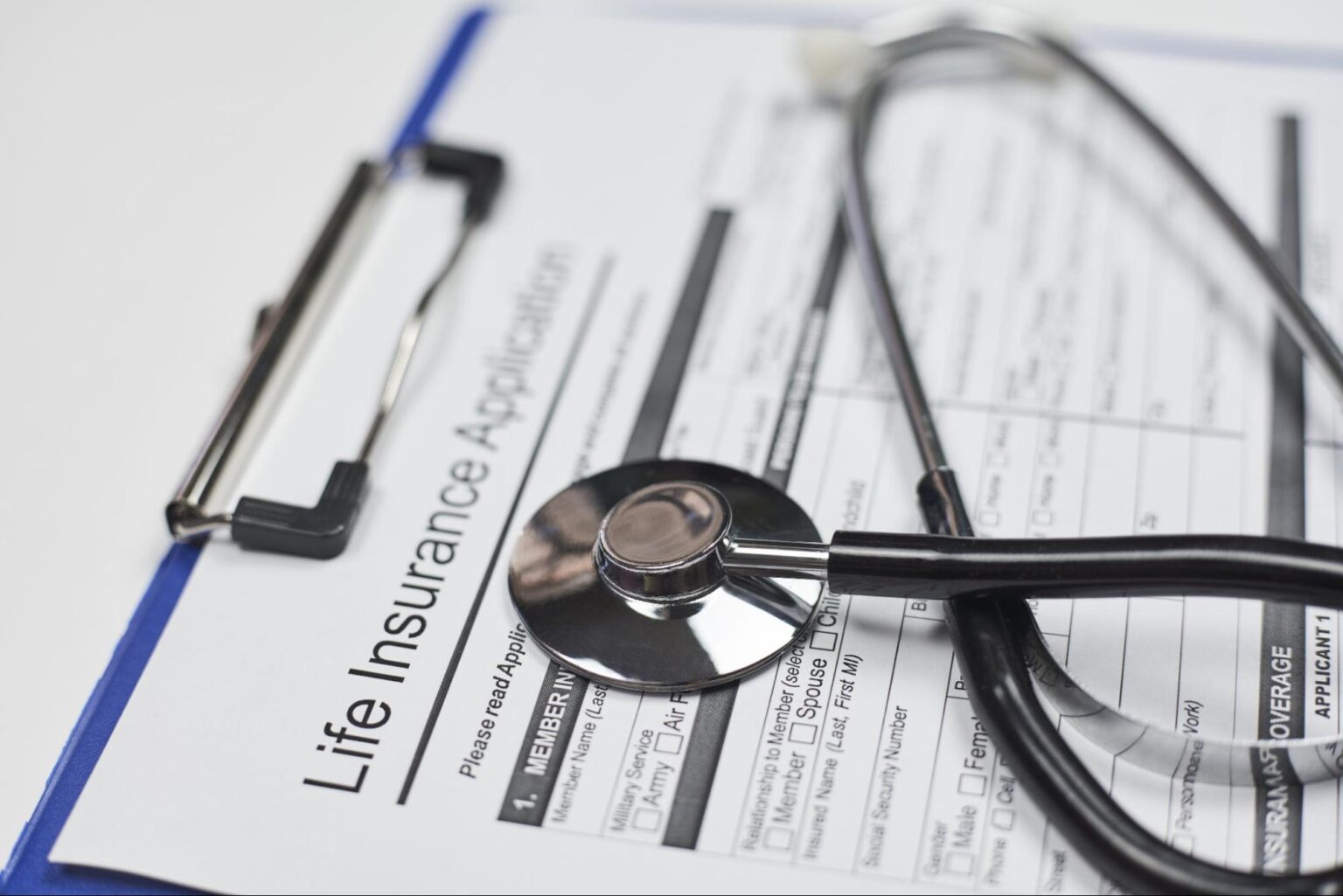 Life insurance application form with a stethoscope for health assessment.