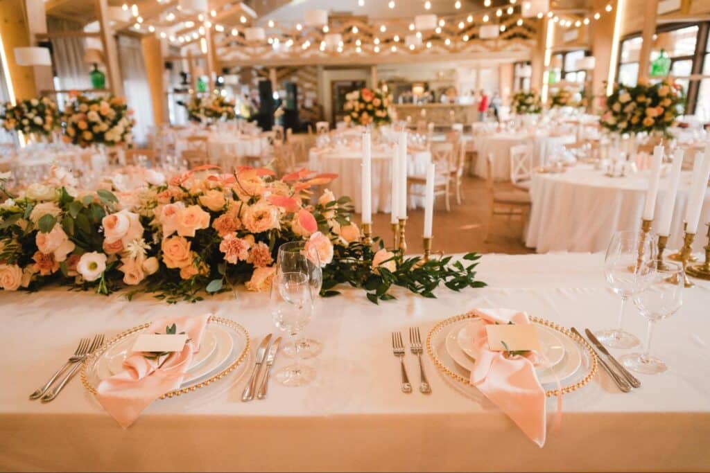 Elegant wedding table setting adorned with flowers and sophisticated dining arrangements.