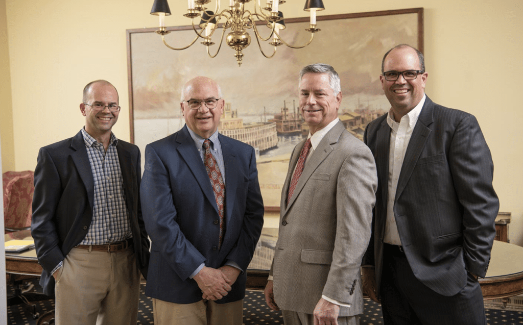 Torian leadership team portrait in a formal office setting with professional attire.