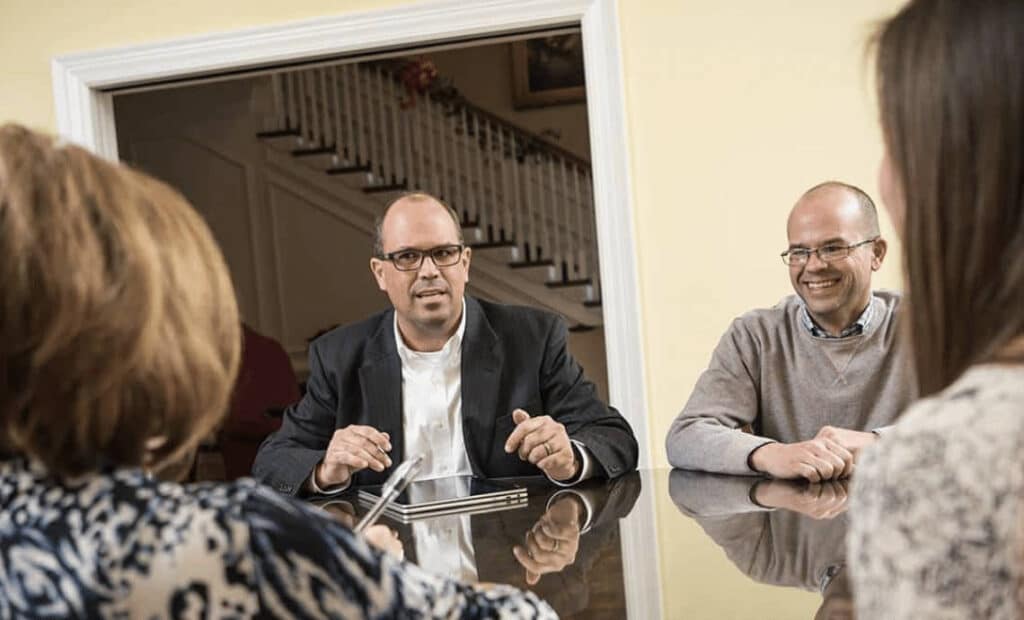 Business meeting around a table with engaged professionals discussing ideas.